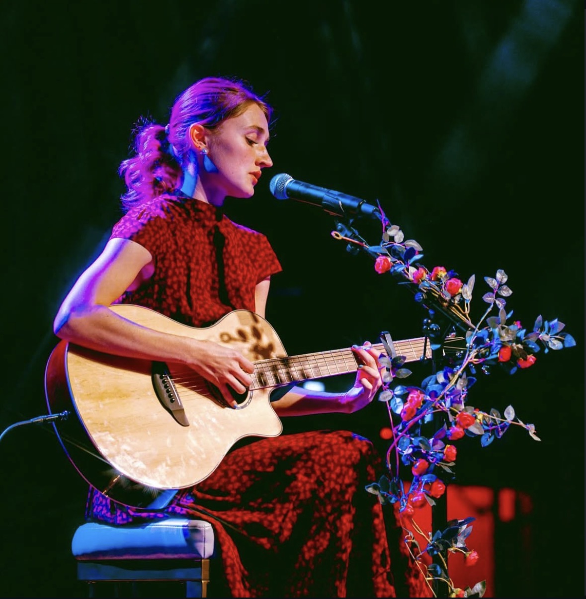 Whitney Hanson performing live poetry and acoustic guitar on tour